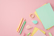Back to school concept. Top view photo of colorful stationery diaries pens round correction tape ruler and adhesive tape on isolated pink background