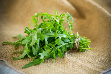 Wall Mural - bunch of fresh juicy green arugula on burlap