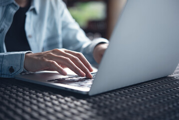 Canvas Print - Business woman typing, working on laptop computer on table at coffee shop, connecting the internet