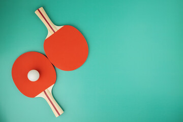 ping pong tournament, two table tennis rackets and a ball on a green background