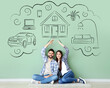 © Pixel-Shot - Young couple dreaming about their new house and car near green wall in room
