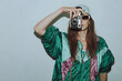 © Julia - Cool teenager. Fashionable girl in colorful trendy jacket and vintage retro sunglasses with camera film in 80s - 90s style. Teenage girl at the disco, on a white background.