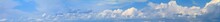 Blue Sky Landscape With White Clouds, Huge Panorama. Horizontal Banner With Free Copy Space For Text