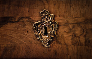 Fototapete - Antique keyhole of an old lock on a wooden background.  Concept and idea on the topic of security, history, protection, guard, secret etc. Rusty lock and keyhole  in a wooden door.