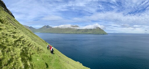 Wall Mural - Trekking with view of the atlantic ocean  and mountains in Faroe Islands 