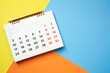 close up of calendar and pencil on the colorful table background, planning for business meeting or travel planning concept