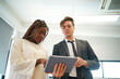 © FotoArtist - Image of young business people discussing document in paperwork data on desk at meeting
