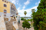 Fototapeta Uliczki - View of the Georgian architecture, Mediterranean Sea and port harbor from the grand staircase leading to the historic old town of Mahon or Mao on the Island of Menorca, Spain.