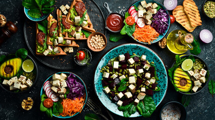 Wall Mural - Healthy vegetarian eating, super food. The concept of healthy eating. On a black stone background. Top view.