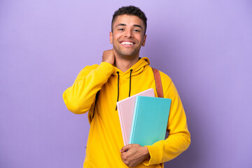 Wall Mural - Young student Brazilian man isolated on purple background laughing