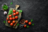 Fototapeta  - Fresh cherry tomatoes. Top view. On a stone background.