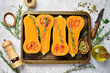 Autumn pumpkin banner. Fresh sliced pumpkin with rosemary and spices. On a stone background. Top view.