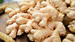 Fresh ginger root. Foods containing vitamin C. Free space for text on a stone background.