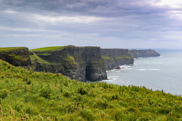  Stunning Cliffs of Moher scenery with ocean and green hill covered cliffs alongside the wild Atlantic way in County Clare Ireland