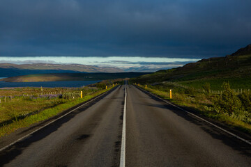 Wall Mural - Very picturesque empty road in iceland in summer. Asphalt road as a symbol of freedom and travel.