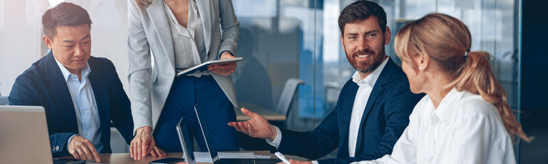 Wall Mural - Woman explaining her ideas to colleagues in conference room at modern office. High quality photo