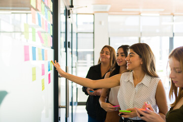 Cheerful women smiling while brainstorming