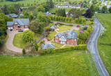 Fototapeta Miasto - Luxury countryside rural village aerial view from above in Quarriers Village in Scotland