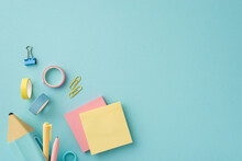 Back To School Concept. Top View Photo Of Colorful Stationery Blue Pencil-case With Pens Sticky Note Paper Adhesive Tape And Binder Clips On Isolated Pastel Blue Background With Copyspace
