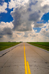 Dramatic cloudscape over the Midwest American road in Iowa. American Heartland landscape photography.