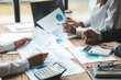 © kamiphotos - The sales department is having a monthly summary meeting to bring it to the department manager, they are verifying the correctness of the documents that are prepared before bringing in to the manager