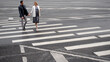 © Ulia Koltyrina - couple in love walks together on a pedestrian crossing, a man and a woman walk in the city, the road
