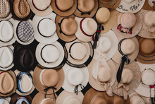 A Variety Of Fashionable And Colorful Hats Are In Outdoor Store Stacked In A Row