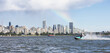 Adventurous Caucasian Woman on Water Scooter riding in the Ocean. Modern City in background. Downtown Vancouver, British Columbia, Canada. Colorful Rainbow