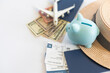 Save money for airplane tickets, planning travel budget concept. Airplane model, piggy bank on wooden table