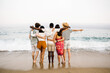 © Xavier Lorenzo - Group of young people hugging each other and enjoying summer at beach