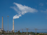 Fototapeta  - Pipes of a power plant on the shores of the Mediterranean Sea. Israel.copy space