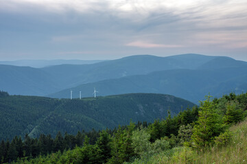  Wind turbines in Bear mountain , view from upper water reservoir of the pumped storage hydro power plant Dlouhe Strane in Jeseniky Mountains, Czech Republic. Summer sunset.