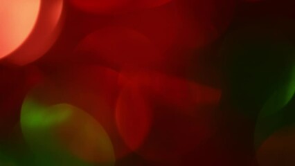 Wall Mural - Christmas bokeh motion. Red and Green defocused circles shimmer, shine and sparkle. Smooth movement of red and green New Year's bokeh on a dark background.