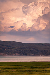 Wall Mural - dramatic clouds over the mountains and lakes in sunset