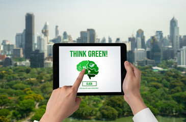 Green business transformation for environment saving and ESG business concept. Businessman using tablet to set corporate goal toward environmental friendly management and alternative clean energy use.