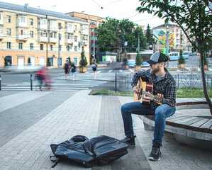 Wall Mural - Male street musician plays the acoustic guitar.