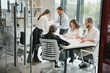 © Serhii - Group of young people in business meeting