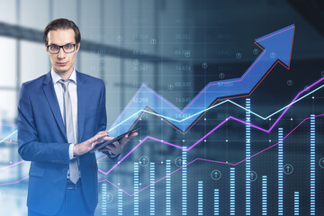 Poster - businessman using tablet with abstract growing business arrow and chart on blurry office interior background with index grid. FInancial data, trade and market concept. Double exposure.