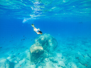 Wall Mural - beautiful woman swimming underwater with snorkeling mask and flippers