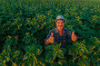 hispanic american man satisfied farmer looking at camera and showing thumb up