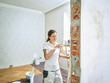 © Westend61 - Happy painter painting doing final painting in apartment