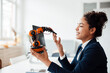 © Westend61 - Smiling businesswoman with robotic arm sitting in office