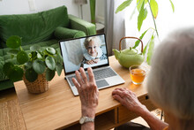 Woman Talking On Video Call With Granddaughter Through Laptop At Home