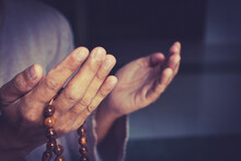 Muslim Man In Brown Session Lift Two Hand For Praying And Wearing Bead On Hand To Determine The Number Of Prayer Services.concept For Ramadan, Eid Al Fitr, Eid Ad-ha, Meditation, Islamic Praying