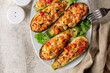 Zucchini stuffed with chicken meat, belle peppers, tomatoes and cheese. Baked in oven. Above.