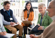 © Halfpoint - Excited elderly people attending group therapy session at nursing house, positive senior man and woman sitting in circle, having conversation with psychologist