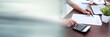 © thodonal - Female hands making calculation; panoramic banner