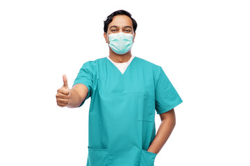 Wall Mural - healthcare, profession and medicine concept - indian doctor or male nurse in blue uniform and face protective medical mask for protection from virus disease showing thumbs up over white background