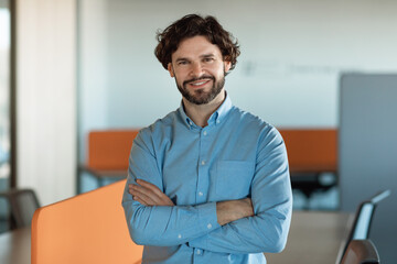 Poster - Portrait of confident smiling mature businessman in shirt standing in modern company office