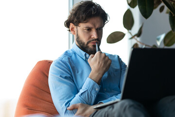 Poster - Thoughtful concentrated middle aged businessman using laptop, having problem with job at modern office